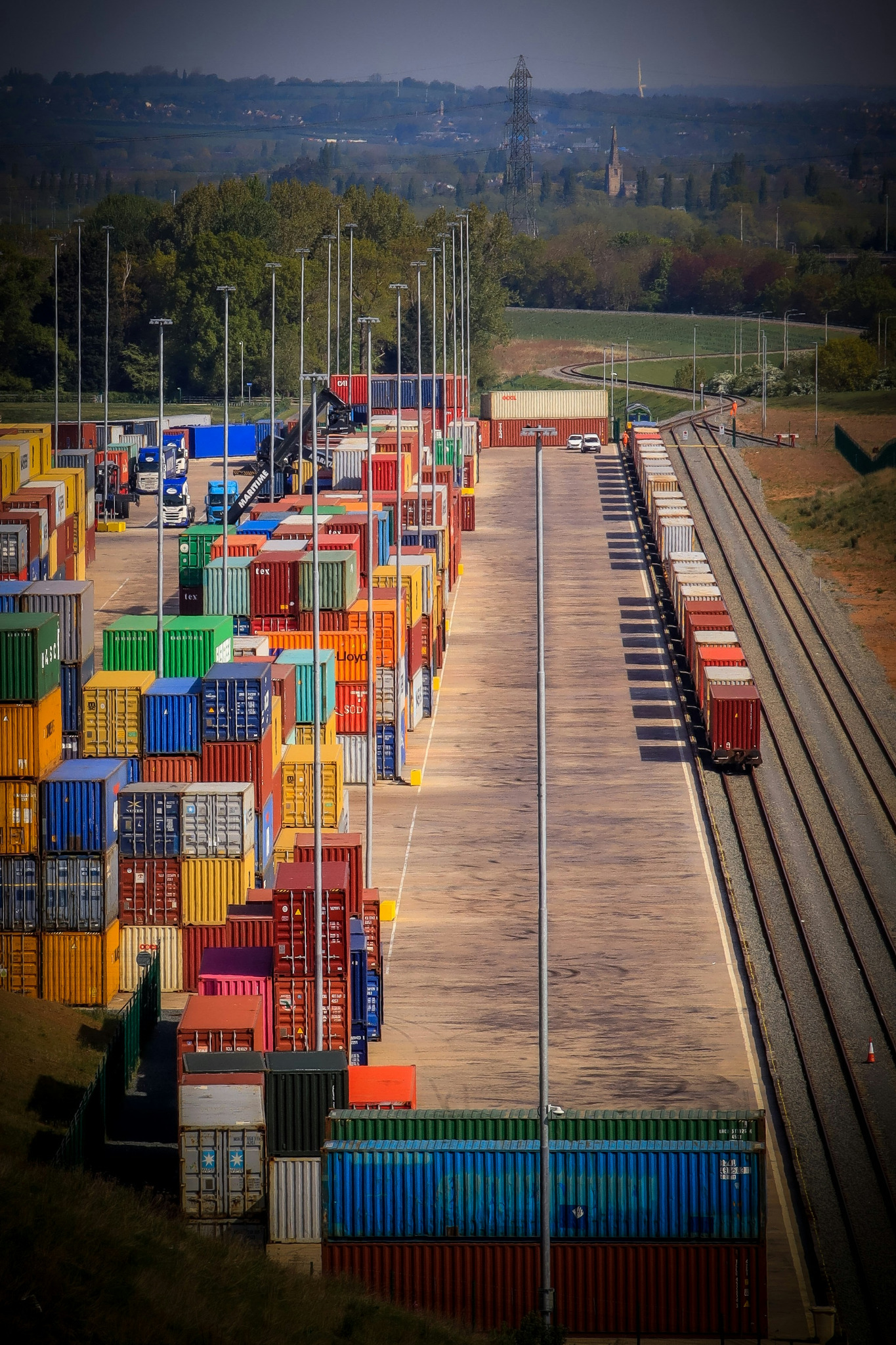 Logistics yard with containers and rail lines